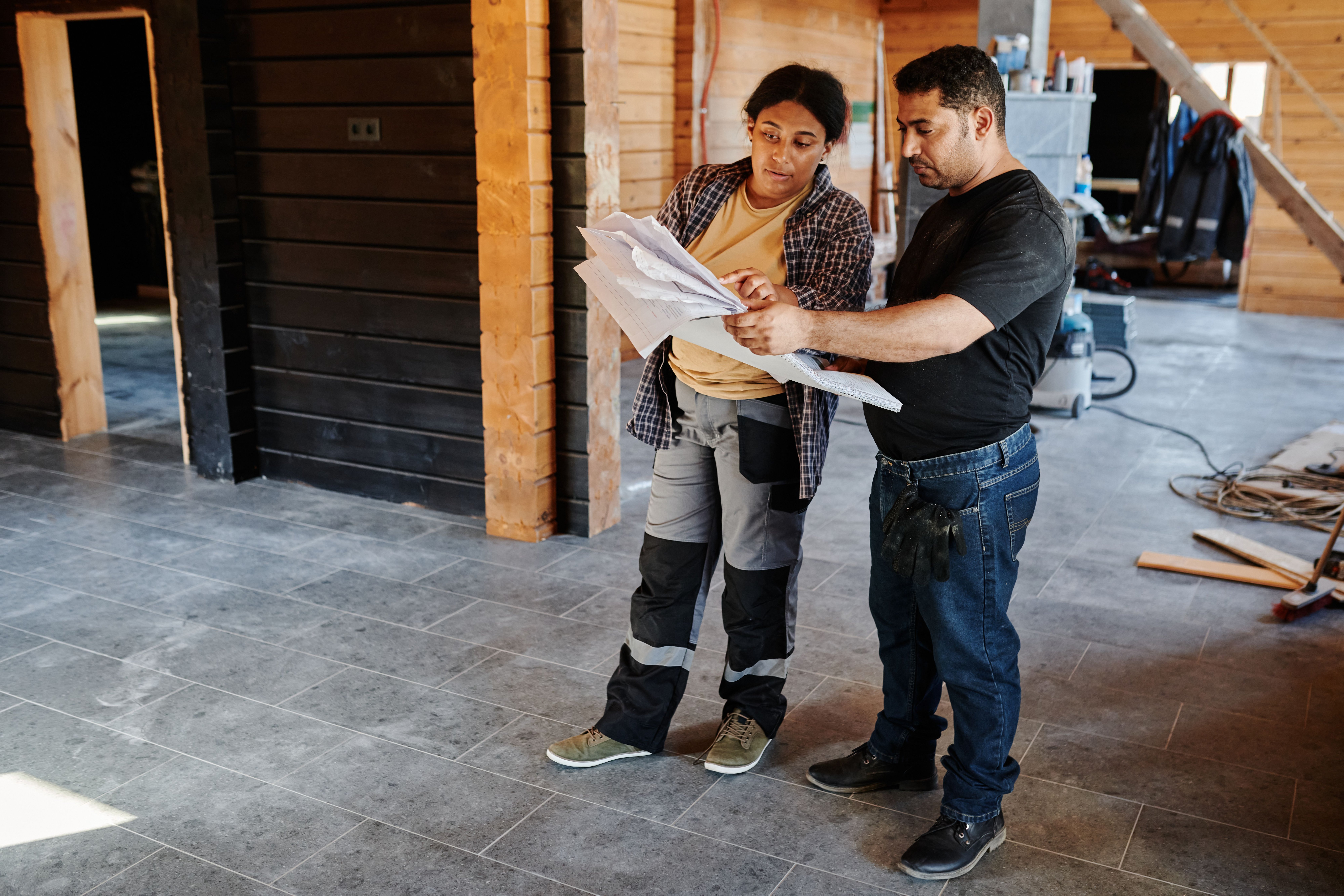Contractor and client reviewing project plans on site